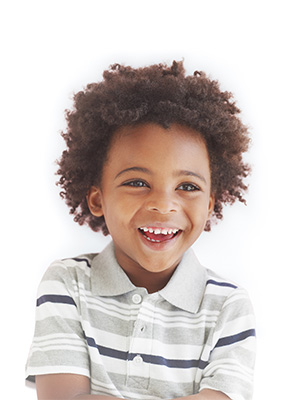 A child smiles while posing for a picture