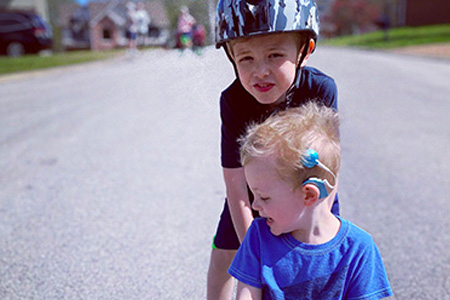 Kids playing in the street with skateboard and helmet